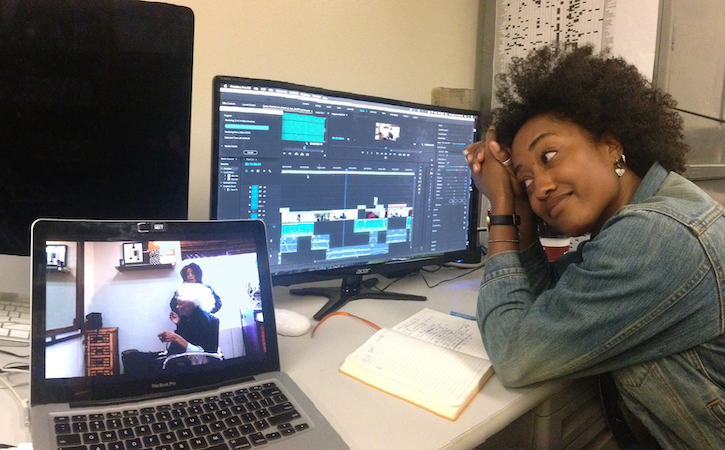 Student in front of two computer screens