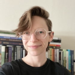 head shot of person with short hair and glasses